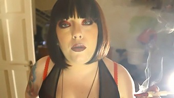 Tina Smua, The Dominating Fatty, Puffs On A Unfiltered Cigarette Using A Holder.